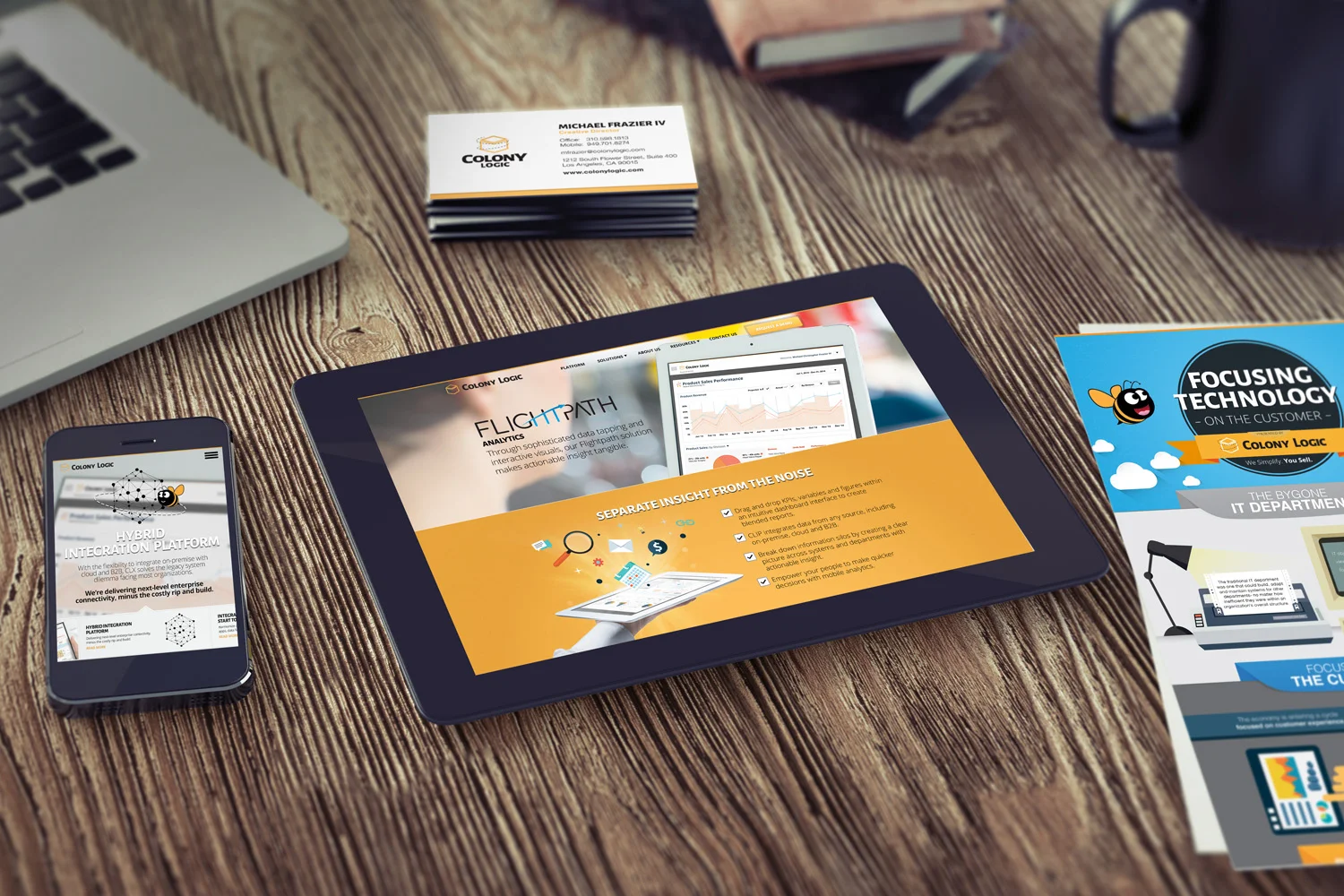 The identity in use: business cards, the campaign infographic and the site on tablet and phone.